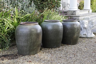 Lot 811 - Three large terracotta green-glazed jars