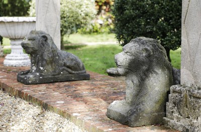 Lot 827 - A pair of cast stone recumbent lions