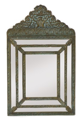 Lot 458 - An embossed brass double-cushion framed mirror