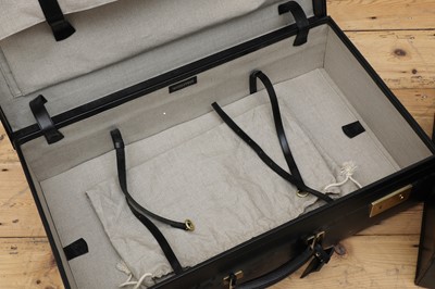 Lot 38 - Two graduated black leather suitcases by Tanner Krolle