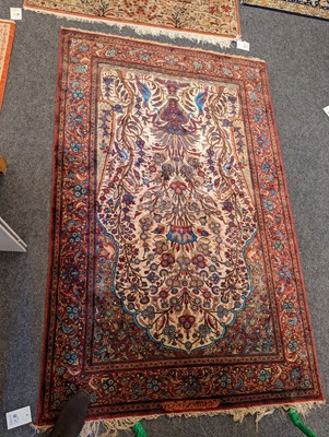 Lot 237 - A Persian silk carpet