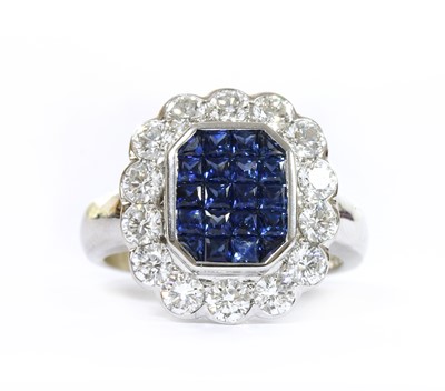 Lot 1211 - An 18ct white gold sapphire and diamond cluster ring