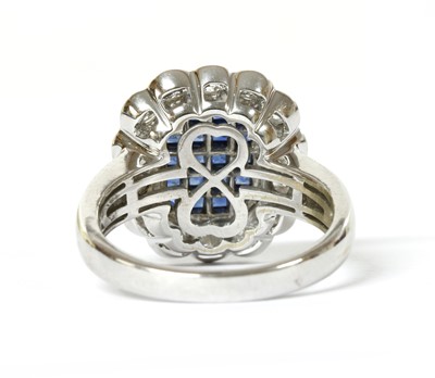 Lot 1211 - An 18ct white gold sapphire and diamond cluster ring