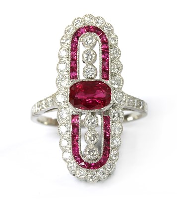 Lot 1141 - A platinum ruby and diamond fingerline cluster ring