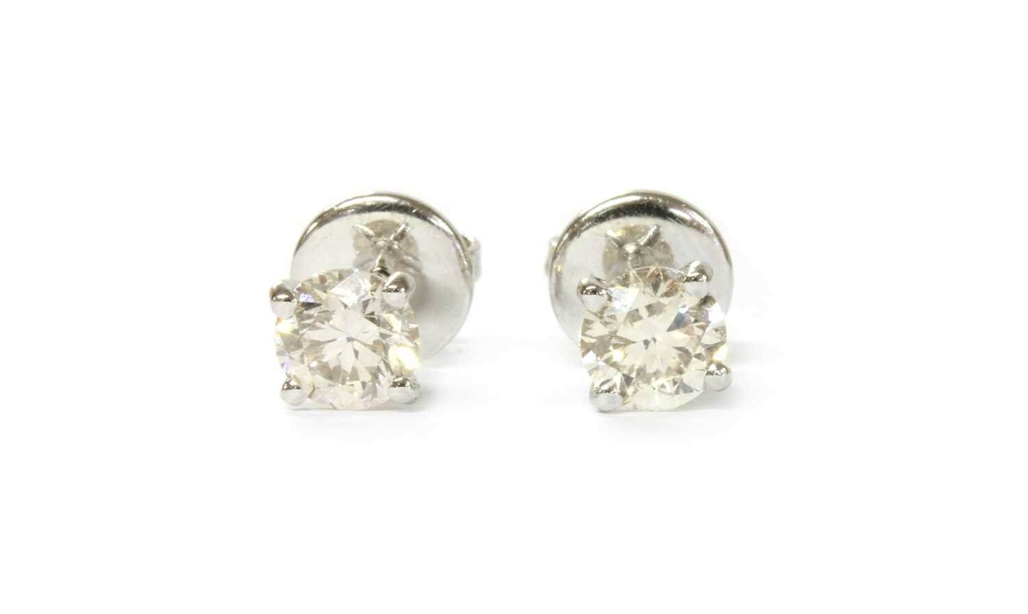 Lot 1120 - A pair of 18ct white gold single stone diamond stud earrings