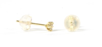 Lot 1092 - A pair of gold single stone diamond stud earrings