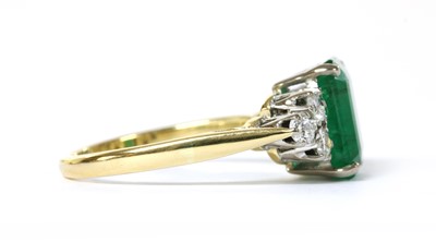 Lot 1193 - A gold emerald and diamond ring