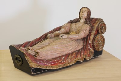 Lot 802 - A polychrome painted wooden figure of a reclining female