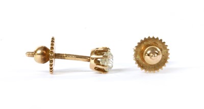 Lot 1011 - A pair of gold single stone diamond stud earrings