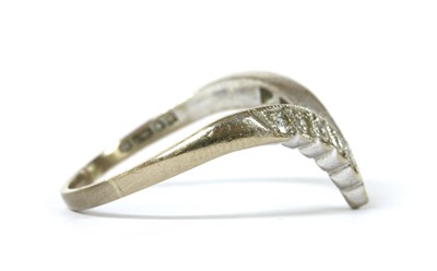 Lot 1127 - An 18ct white gold diamond set wishbone ring