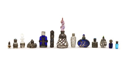 Lot 69 - A collection of white metal mounted scent bottles