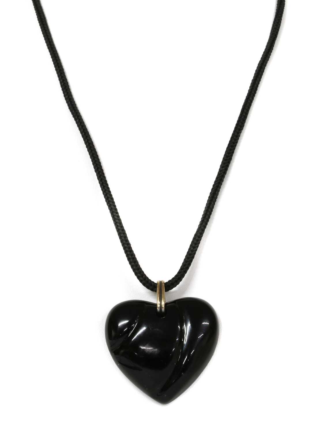 Lot 1276 - A black glass heart shaped pendant, by Baccarat