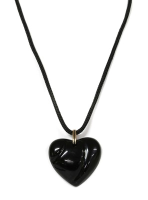 Lot 1276 - A black glass heart shaped pendant, by Baccarat