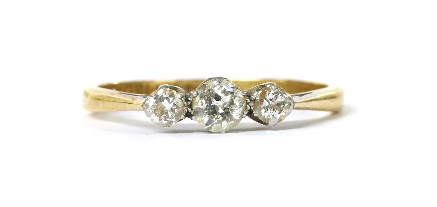 Lot 1098 - A gold three stone diamond ring