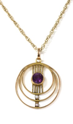 Lot 1051 - An Edwardian gold amethyst and seed pearl pendant