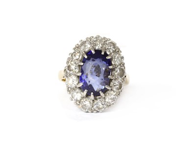 Lot 199 - A sapphire and diamond oval cluster ring