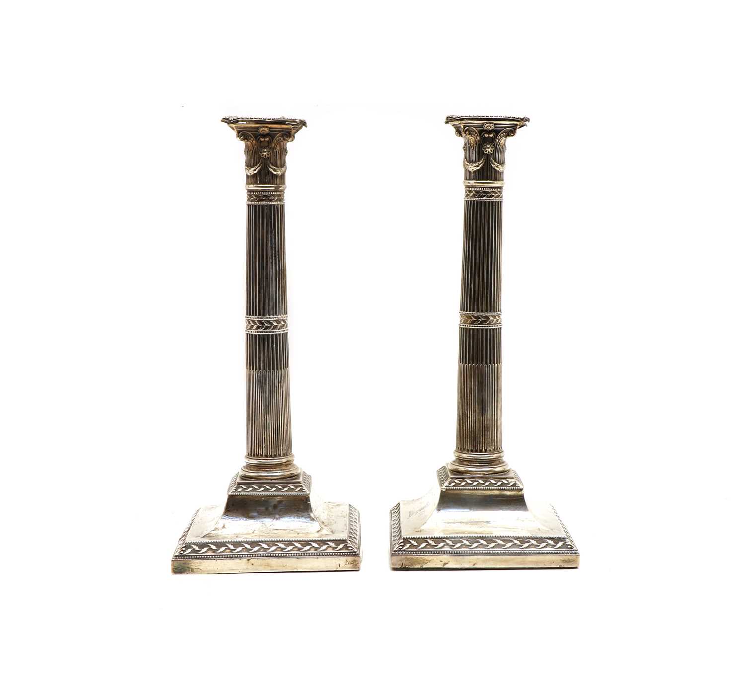 Lot 12 - A pair of George III silver candlesticks