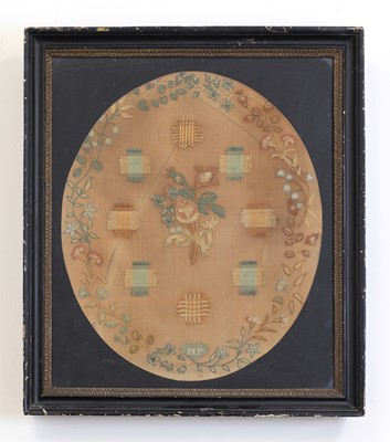 Lot 534 - An oval darning sampler