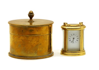 Lot 220 - A miniature brass carriage clock of oval form