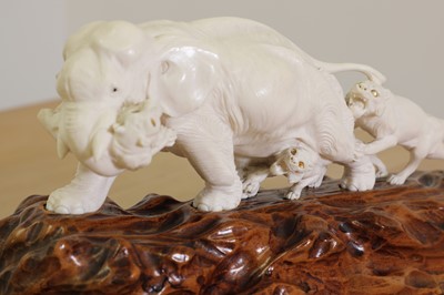 Lot 179 - A Japanese carved ivory elephant and lion group