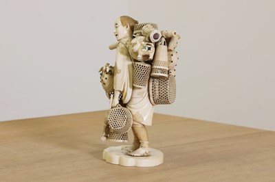 Lot 177 - A Japanese carved ivory sectional figure of a basket seller