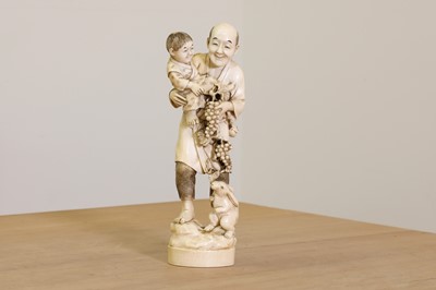 Lot 175 - A Japanese solid carved ivory figure of a man carrying a child