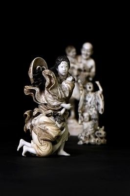 Lot 170 - A Japanese solid carved ivory family group