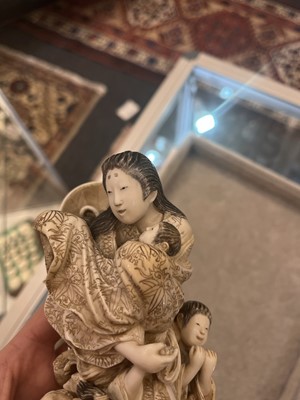 Lot 170 - A Japanese solid carved ivory family group