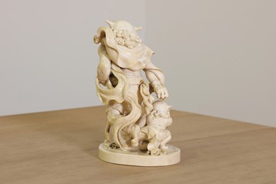Lot 154 - A Japanese solid carved ivory oni okimono