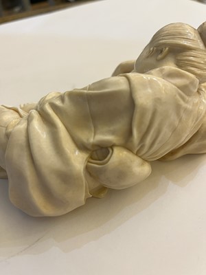 Lot 161 - A Japanese carved ivory figure of a lady asleep