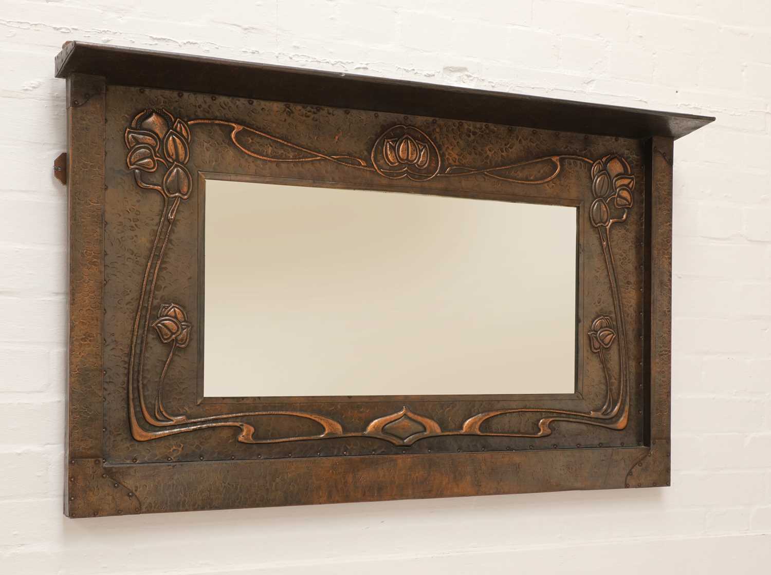 Lot 141 - An Art Nouveau copper mirror