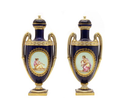 Lot 256 - A pair of late 19th century Royal Vienna style twin handled lidded vases