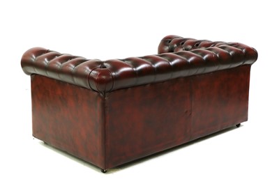 Lot 544 - A leather two seater Chesterfield sofa