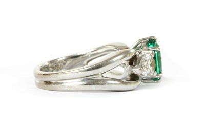 Lot 1183 - A white gold emerald and diamond three stone ring