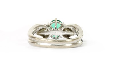 Lot 1183 - A white gold emerald and diamond three stone ring