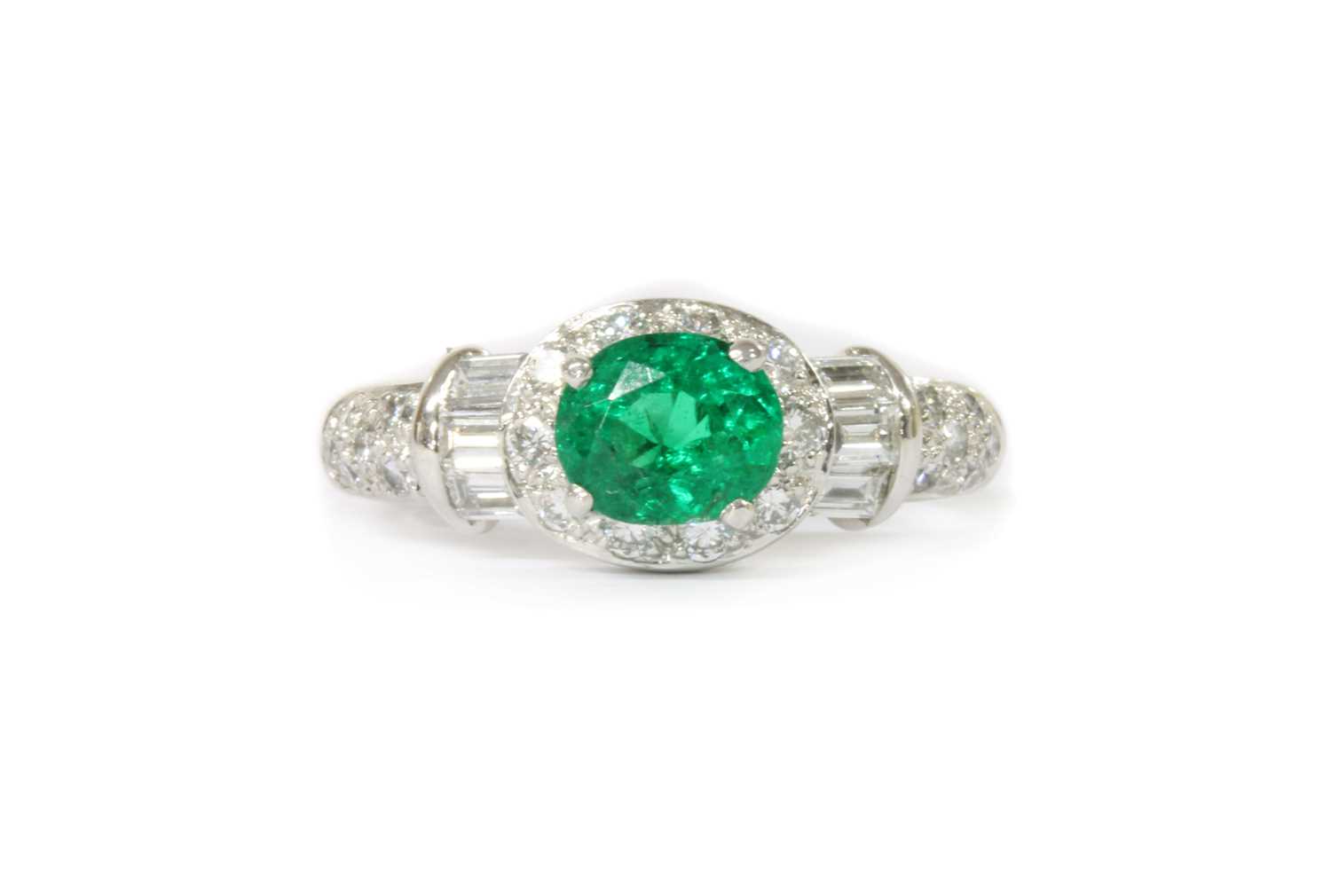 Lot 1186 - A platinum emerald and diamond cluster ring