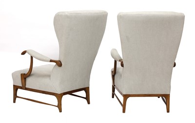 Lot 411 - A pair of walnut and upholstered wingbacked armchairs
