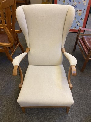 Lot 411 - A pair of walnut and upholstered wingbacked armchairs
