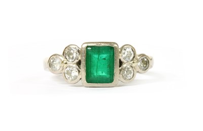 Lot 1194 - An 18ct white gold emerald and diamond ring