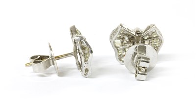 Lot 1132 - A pair of white gold diamond earrings