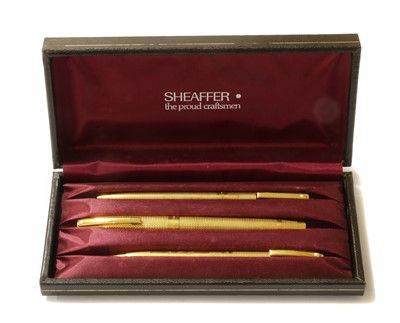 Lot 1355 - An 18ct gold three piece pen and pencil set, by Sheaffer
