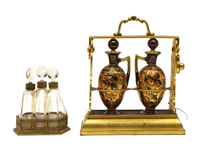 Lot 251 - A small Victorian tantalus with two porcelain bottles