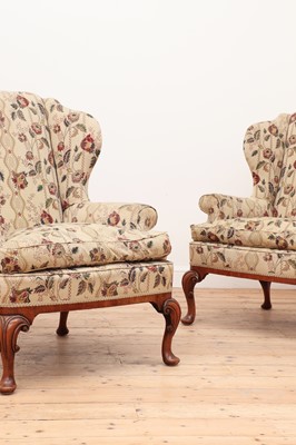 Lot 638 - A pair of George III-style walnut wing-back armchairs