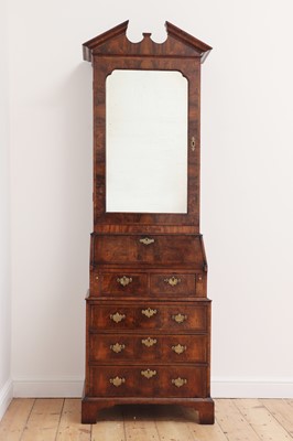 Lot 637 - A George II-style walnut feather-banded bureau bookcase