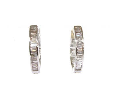 Lot 195 - A pair of white gold diamond huggie hoop earrings