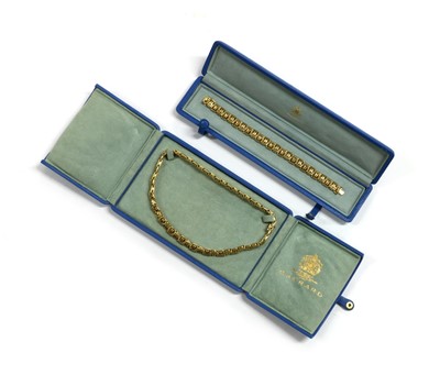 Lot 1074 - An 18ct gold necklace and bracelet suite, by Garrard