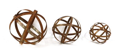 Lot 474 - A graduated set of three contemporary rusted metal strapwork spheres