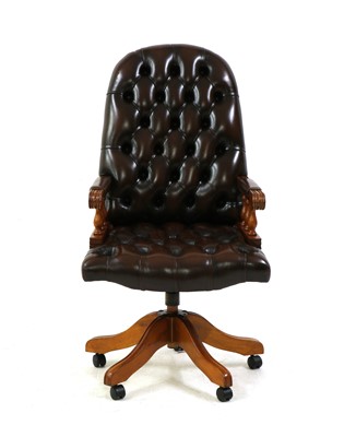 Lot 475 - A button back leather office swivel chair