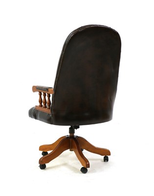Lot 475 - A button back leather office swivel chair