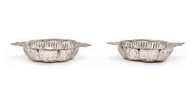 Lot 71 - A pair of pierced twin handled silver bon bon dishes
